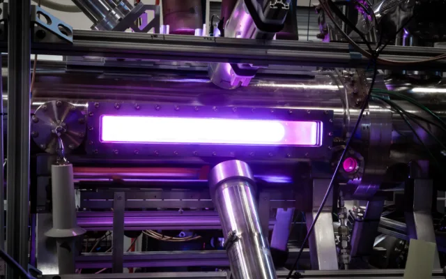 Pink-purple light glows from a Zap Energy fusion device